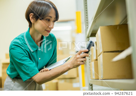 Young woman managing inventory while scanning Young woman managing inventory while scanning 94287621