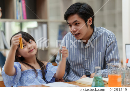Kid and teacher doing science experiments. back to school concept Kid and teacher doing science experiments. back to school concept 94291249