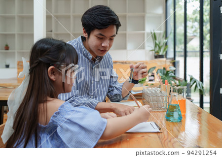 Kid and teacher doing science experiments. back to school concept Kid and teacher doing science experiments. back to school concept 94291254