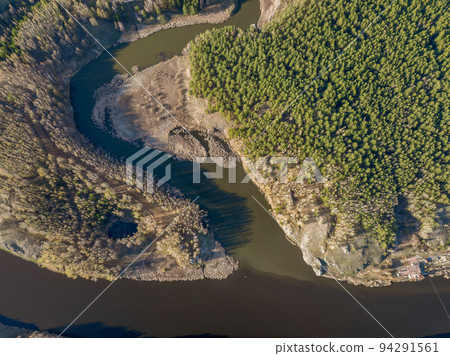 Aerial view of river shore with rocks and forest. Spring or autumn season. Iset River, Ural mountains, Russia. Aerial view of river shore with rocks and forest. Spring or autumn season. Iset River, Ural mountains, Russia. 94291561