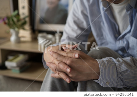 Portrait of loneliness Middle-aged man drooping in front of the altar Portrait of loneliness Middle-aged man drooping in front of the altar 94293141
