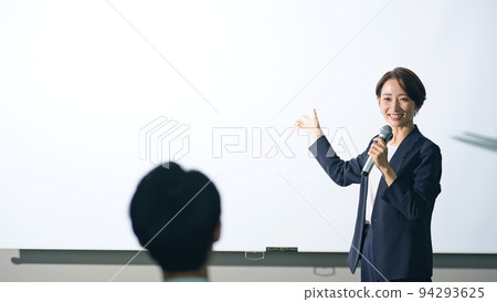Women on stage and audience seminar presentation 94293625