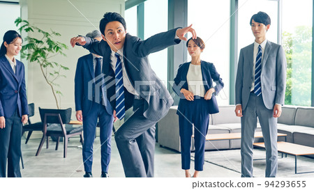 A business group dancing in the office 94293655