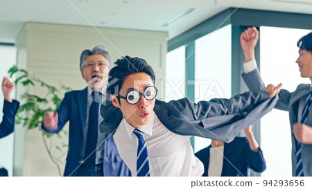 A business group dancing in the office 94293656