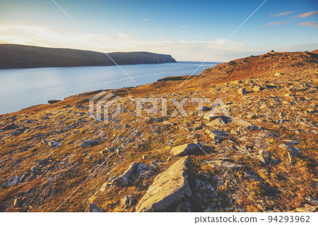 View of the fjord. Rocky seashore with blue cloudy sky. Beautiful nature Norway. Arctic Bay. Mageroya island. Nordkapp. Arctic ocean. View of the fjord. Rocky seashore with blue cloudy sky. Beautiful nature Norway. Arctic Bay. Mageroya island. Nordkapp. Arctic ocean. 94293962