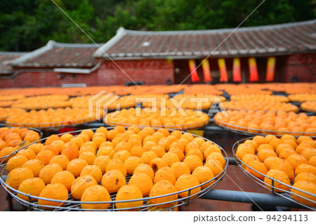 Ripe orange persimmons, peeled and exposed to the sun. Ripe orange persimmons, peeled and exposed to the sun. 94294113