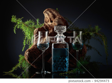 Blue gin and Juniper branches on a black background. Blue gin and Juniper branches on a black background. 94294473