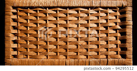 Rattan rectangle wicker brown basket with handmade traditional and dry branches, isolated on black background 94295512