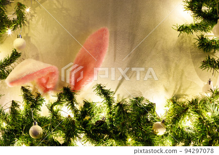 Rabbit ears in the christmas tree on white background. Rabbit ears in the christmas tree on white background. 94297078