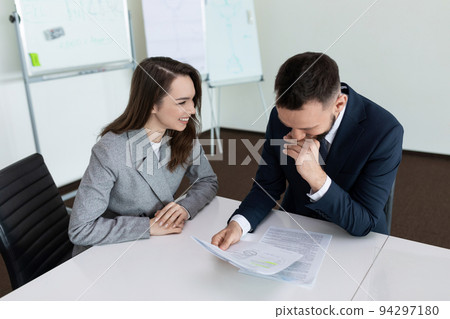 office workers at the table laughing 94297180
