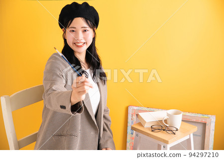 smiling woman holding a brush smiling woman holding a brush 94297210