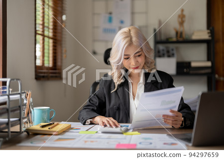 Happy smiling young asian entrepreneur woman counting profit, on calculator at laptop computer, analyzing benefits, enjoying financial success, job high result. Happy smiling young asian entrepreneur woman counting profit, on calculator at laptop computer, analyzing benefits, enjoying financial success, job high result. 94297659