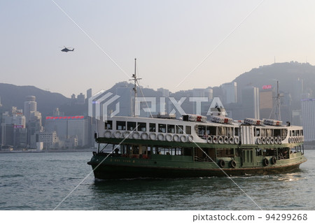 Star ferry sailing through Victoria Bay in Hong Kong 94299268