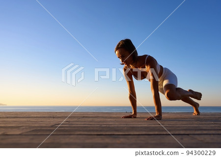 Healthy Yoga woman lifestyle balanced practicing meditate and energy yoga on the bridge in morning Healthy Yoga woman lifestyle balanced practicing meditate and energy yoga on the bridge in morning 94300229