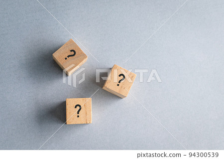 Wooden cube block shape with sign question mark on them. 94300539