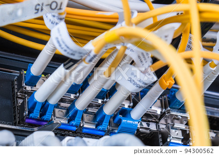 fiber optic cables plugged in network switch panel inside data center fiber optic cables plugged in network switch panel inside data center 94300562