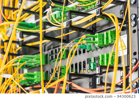 detail of server rack with fiber optic cables attached to front panel switch ports detail of server rack with fiber optic cables attached to front panel switch ports 94300623