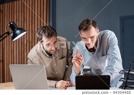 happy business colleagues, checking out the perfect solution for their project. 94304488