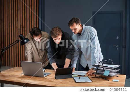 business team working on a new project in a night office. business team working on a new project in a night office. 94304511