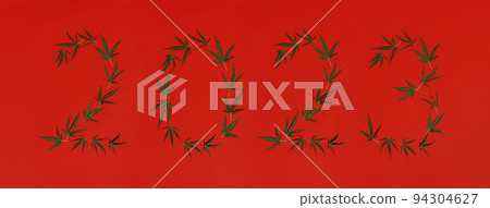 2023 numbers made of cannabis leaves isolated on white with blurred leaves in foreground. Happy New Year concept. Legalize marijuana concept. 94304627