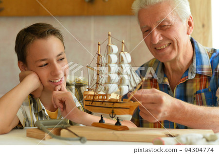 Grandfather and his grandson made a ship model. Grandfather and his grandson made a ship model. 94304774
