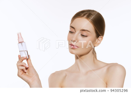 Portrait of young female fashion model with nude makeup isolated on white studio background. Spa, surgery, face lifting and skin care concept 94305296