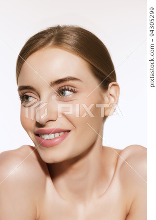 Portrait of young beautiful girl with well-kept skin and light daily makeup isolated on white background. Beauty, spa, cosmetics, face lifting and skin care concept 94305299
