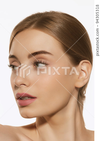 Portrait of young beautiful girl with well-kept skin and light daily makeup isolated on white background. Beauty, spa, cosmetics, face lifting and skin care concept Portrait of young beautiful girl with well-kept skin and light daily makeup isolated on white background. Beauty, spa, cosmetics, face lifting and skin care concept 94305318