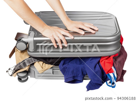 Travel suitcase full of things. Packing a suitcase for a trip. 94306188