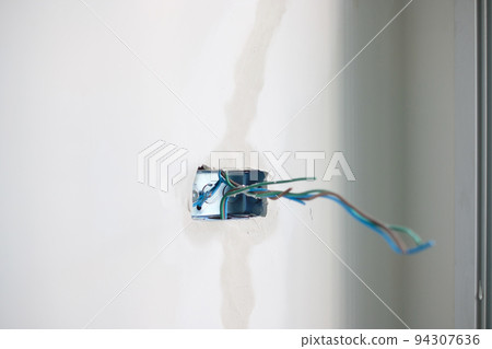Electrical Wiring under plaster, hidden installation cables for socket to a concrete. Renovation, Repair and development of home and apartment concepts Electrical Wiring under plaster, hidden installation cables for socket to a concrete. Renovation, Repair and development of home and apartment concepts 94307636