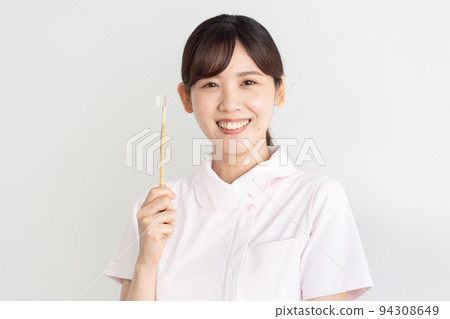 Image of a dental hygienist with a toothbrush 94308649