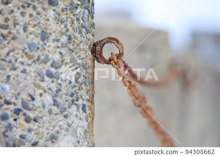Rusty chains in the coastal parking lot Rusty chains in the coastal parking lot 94308662