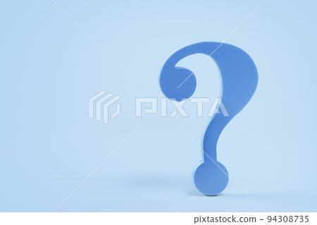 Blue question mark symbol on a desk on blue 94308735