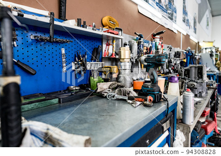 Large workbench with tools at station for vehicle technical servicing 94308828
