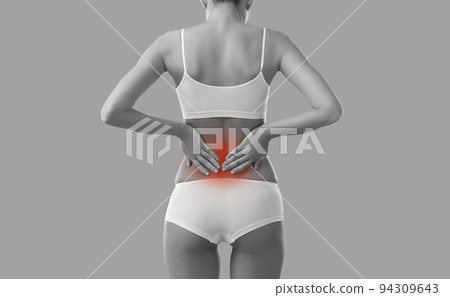B and W cropped image of woman suffering from back or kidney pain, isolated on background. 94309643
