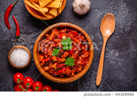 Chili Con Carne in bowl on dark background. 94309998