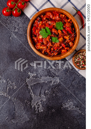 Chili Con Carne in bowl on dark background. Chili Con Carne in bowl on dark background. 94310000