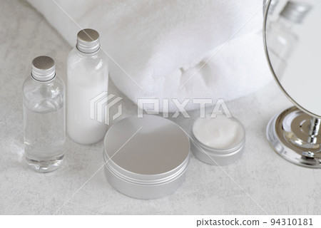 Skin care image of round mirror, white towel and skin care cosmetics Skin care image of round mirror, white towel and skin care cosmetics 94310181