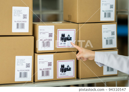 Female staff checking the inventory status of lithium-ion batteries Female staff checking the inventory status of lithium-ion batteries 94310547