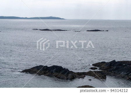 Boulders among the waters of the Atlantic Ocean. Seascape. Cold spring in Ireland, northern Europe. Celtic Sea in cloudy weather. Seaside landscape. Blue sea under sky Boulders among the waters of the Atlantic Ocean. Seascape. Cold spring in Ireland, northern Europe. Celtic Sea in cloudy weather. Seaside landscape. Blue sea under sky 94314212