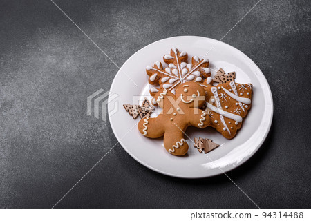 Christmas homemade gingerbread cookies on a dark concrete table Christmas homemade gingerbread cookies on a dark concrete table 94314488