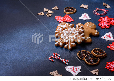 Christmas homemade gingerbread cookies on a dark concrete table Christmas homemade gingerbread cookies on a dark concrete table 94314499