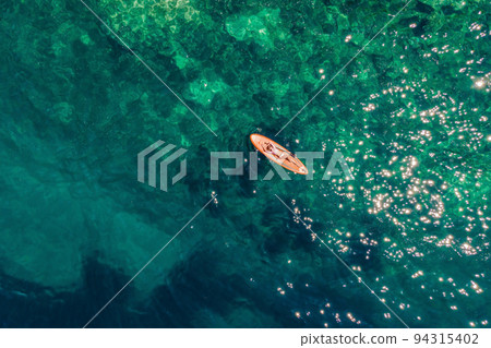 Young women Having Fun Stand Up Paddling in blue water sea in Montenegro. SUP. girl Training on Paddle Board near the rocks Portrait of a disgruntled girl sitting at a cafe table Young women Having Fun Stand Up Paddling in blue water sea in Montenegro. SUP. girl Training on Paddle Board near the rocks Portrait of a disgruntled girl sitting at a cafe table 94315402