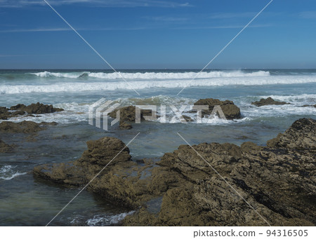 View sea shore with ocean waves, sharp rocks and stones at Rota Vicentina wild coast near Porto Covo, Portugal. 94316505