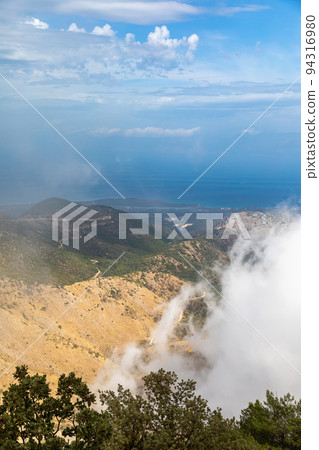Landscape in the clouds under Mount Pantokrator on the island of Corfu Landscape in the clouds under Mount Pantokrator on the island of Corfu 94316980