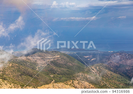 Landscape in the clouds under Mount Pantokrator on the island of Corfu Landscape in the clouds under Mount Pantokrator on the island of Corfu 94316986