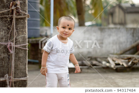 Cute smart naughty baby making a funny and looking at camera. Happy baby background. Cute smart naughty baby making a funny and looking at camera. Happy baby background. 94317484