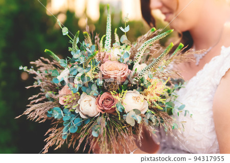 Nice Wedding Bouquet in Bride's Hands, Close Up 94317955
