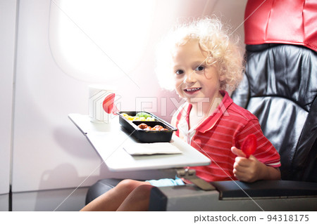 Child in airplane. Kids fly. Children flight meal 94318175