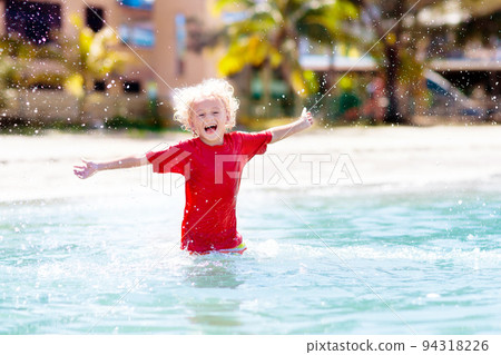 Kids playing on beach. Children play at sea. Kids playing on beach. Children play at sea. 94318226